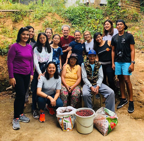 Manang Mina and Uncle Ernesto (seated, centre and right) with coffee harvest volunteers from the Philippines, Canada, and the U.S. Photo by Kapé, Beanstock Coffee Festival.