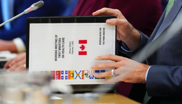 Prime Minister Justin Trudeau flipped open a briefing book when he met with Canada's premiers in Ottawa on Tuesday, Feb. 7, 2023. (Credit: Photo by Sean Kilpatrick/The Canadian Press in Darren Major·CBC News·Feb 13, 2023)