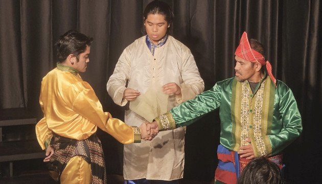 Sean Penola and Geoffrey Penola enact a tribal peace pact before Raine Hermosa.