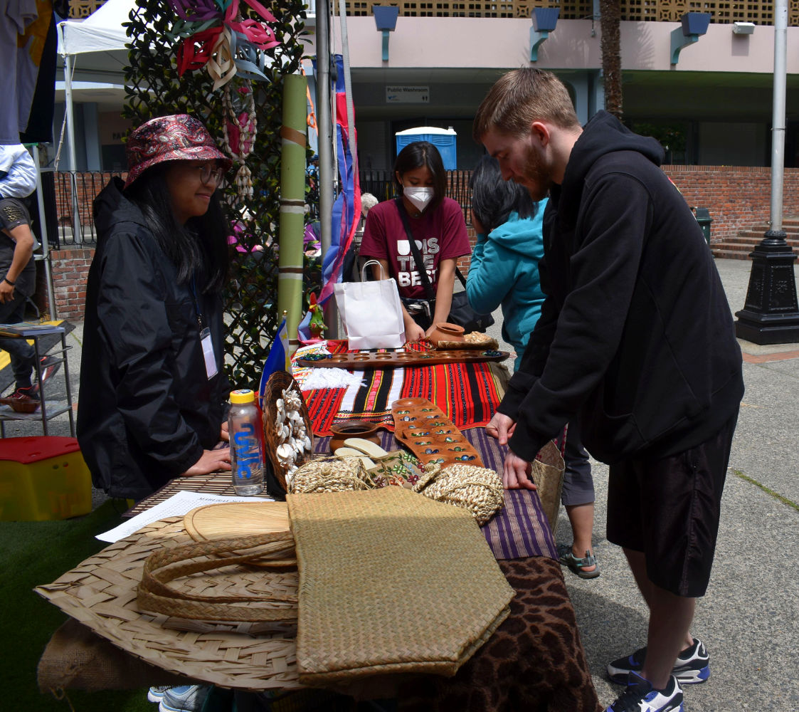 A guest tries his hand at playing sungka, a popular Filipino board game.