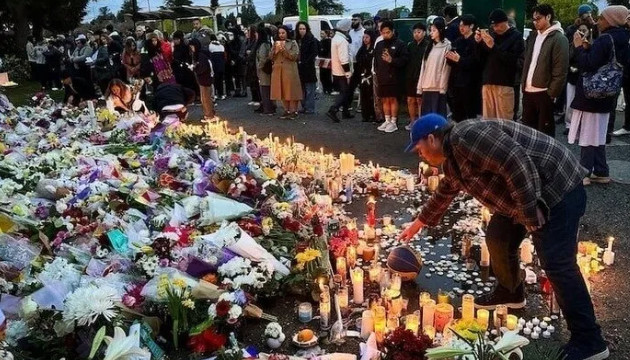 Mourners gather at a temporary memorial for festival victims last year.