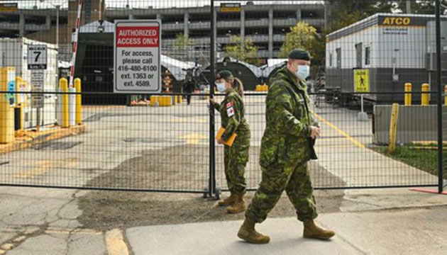 Military healthcare personnel prepare for patients at a mobile health unit at Sunnybrook Hospital in Toronto (Credit: Nathan Denette. The Canadian Press. April 27, 2021.)